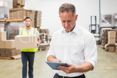 Focused boss using digital tablet