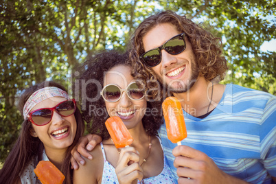 Hipster friends enjoying ice lollies