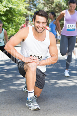 Smiling man warming up before race