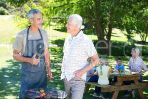 Happy man doing barbecue with his father