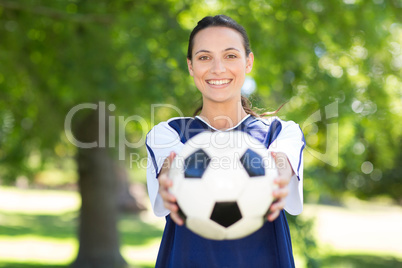 Pretty football player smiling at camera