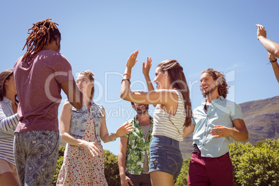 Young hipster friends dancing together