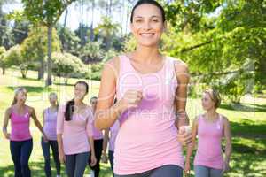 Smiling women in pink for breast cancer awareness