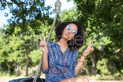 Pretty young woman in tire swing