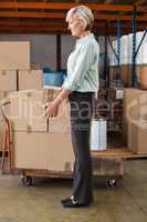 Warehouse manager holding cardboard box