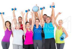 Excited people with exercise equipment raising hands