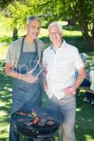 Happy man doing barbecue with his father