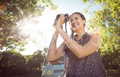 Pretty hipster taking a photo