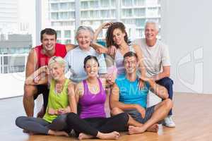 Happy people in sportswear at fitness studio