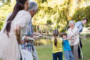 Extended family having tug of war