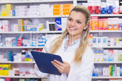 Pharmacy intern writing on clipboard