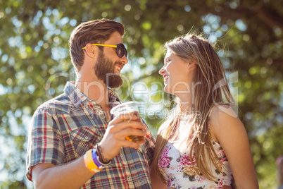 Hipster couple smiling at each other