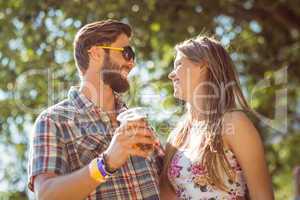 Hipster couple smiling at each other