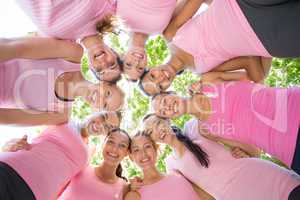 Smiling women organising event for breast cancer awareness