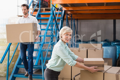 Warehouse managers loading a trolley