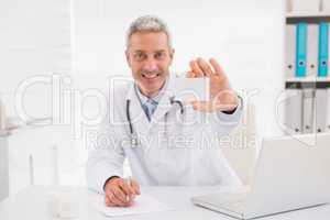 Smiling doctor showing a blank