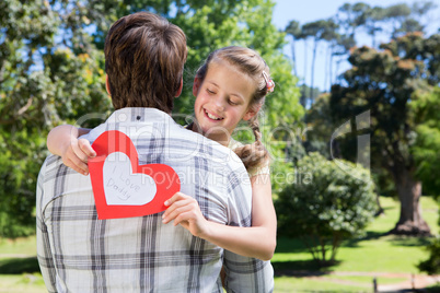 Father and daughter hugging in the park