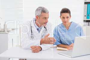 Doctors looking at laptop