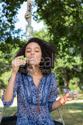 Pretty young woman in tire swing