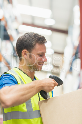 Smiling manual worker scanning package