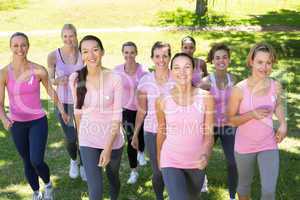 Smiling women in pink for breast cancer awareness