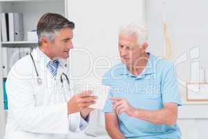 Doctor explaining prescription to senior patient