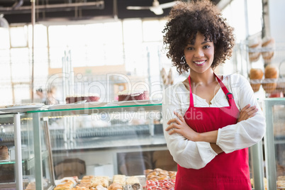 Pretty employee posing with arms crossed