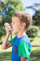 Little boy using his inhaler