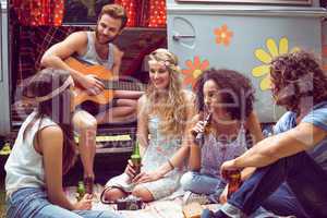 Hipster friends by camper van at festival