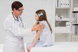 Doctor examining little girl