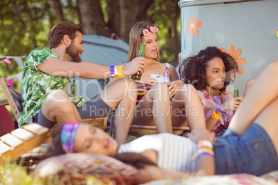 Happy hipsters relaxing on the campsite