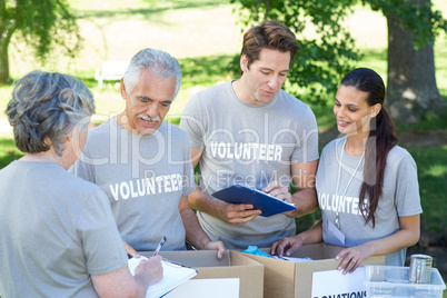 Happy volunteer writing on clipboard