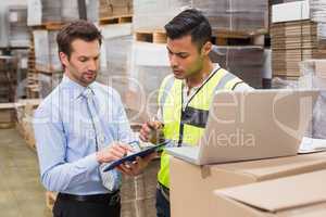 Warehouse worker and manager working together