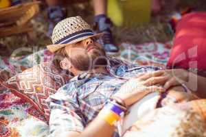 Handsome hipster relaxing on campsite