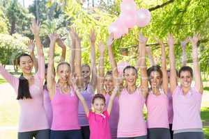 Smiling women in pink for breast cancer awareness