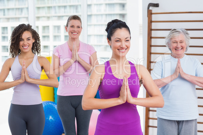 Friends with hands clasped standing in gym