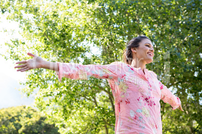 Pretty brunette feeling free in the park