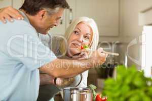 Mature couple preparing vegetarian meal together