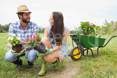 Happy young couple gardening together