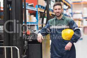 Manual worker leaning against the forklift