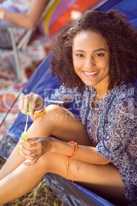 Carefree hipster blowing bubbles in tent