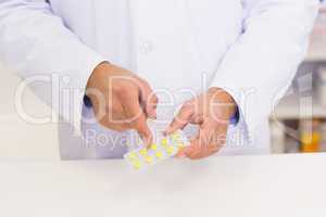 Pharmacist holding blister packs