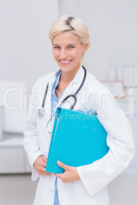 Confident female doctor holding file