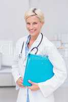 Confident female doctor holding file