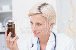 Doctor looking at medicine bottle