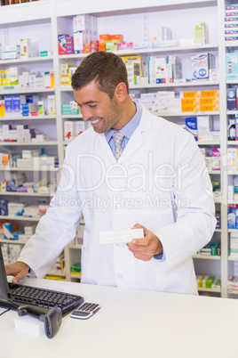 Handsome pharmacist holding medicine box