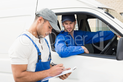 Delivery man getting signature from customer