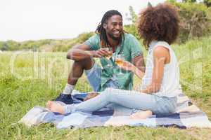 Young couple on a picnic drinking wine