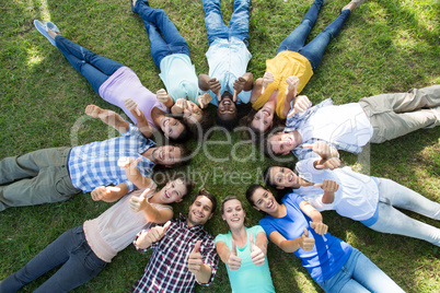 Happy friends in the park lying in circle