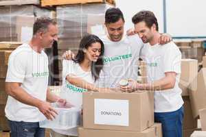 Volunteer team packing a food donation box